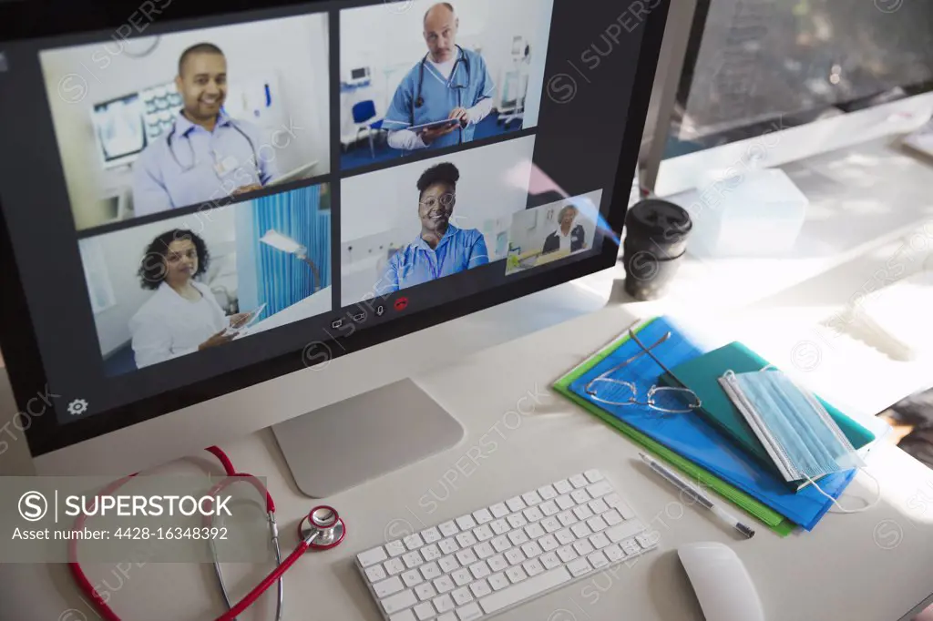 Doctors and nurse video conferencing on computer screen