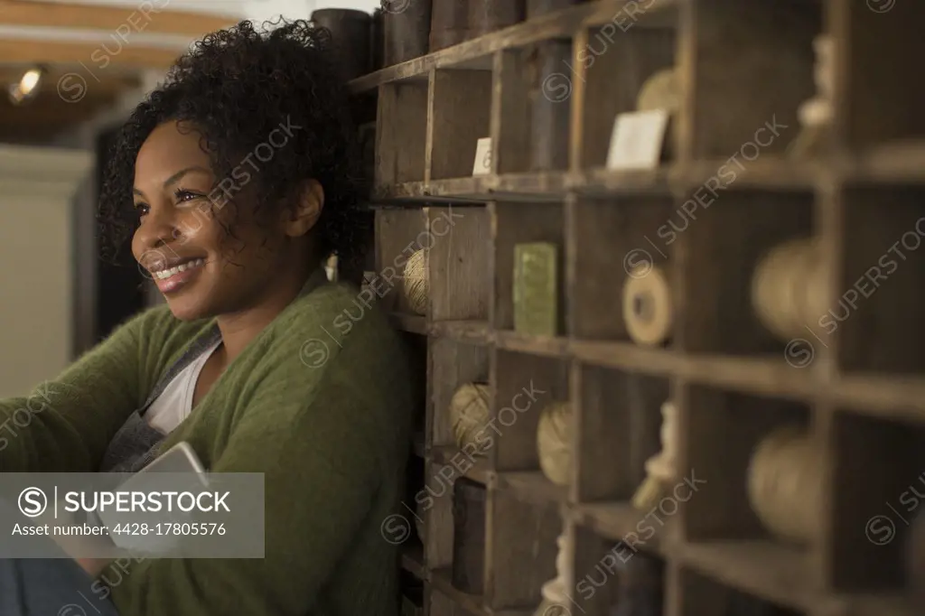 Happy female shop owner at vintage display
