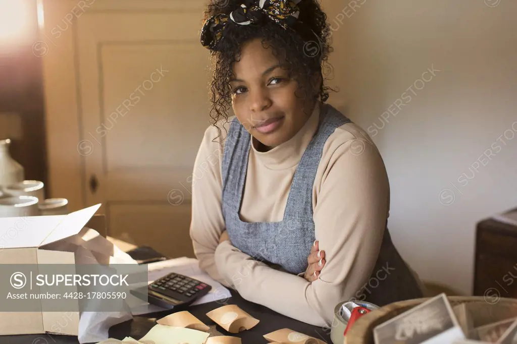 Portrait confident female shop owner packaging e-commerce box