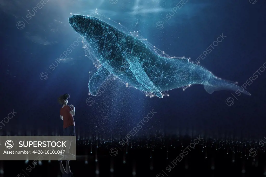 Curious boy in VR headset looking up at holographic humpback whale