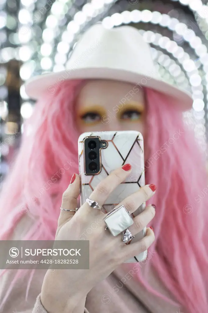 Portrait beautiful woman with pink hair taking selfie with smart phone