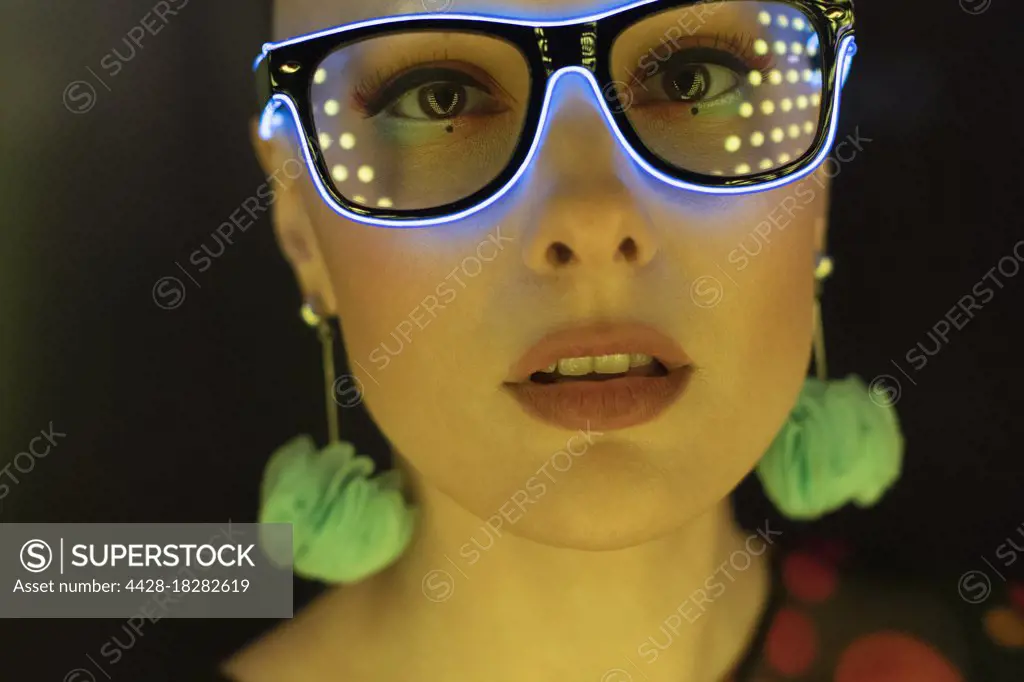 Close up portrait beautiful stylish woman in neon glasses