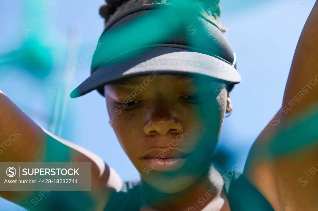 Close up determined female track and field athlete in visor