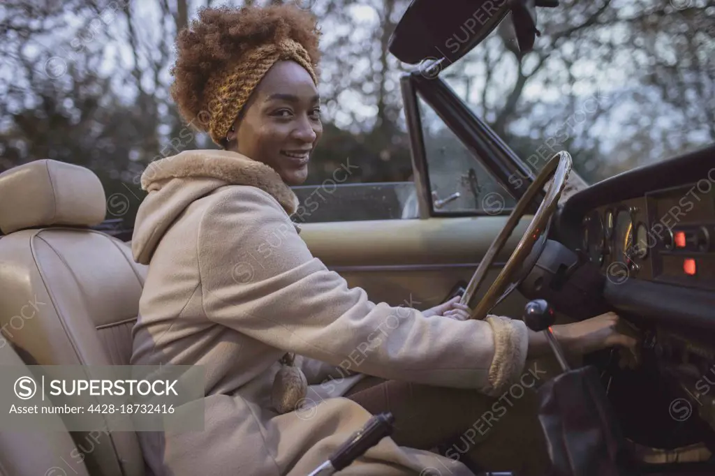 Portrait beautiful young woman driving convertible