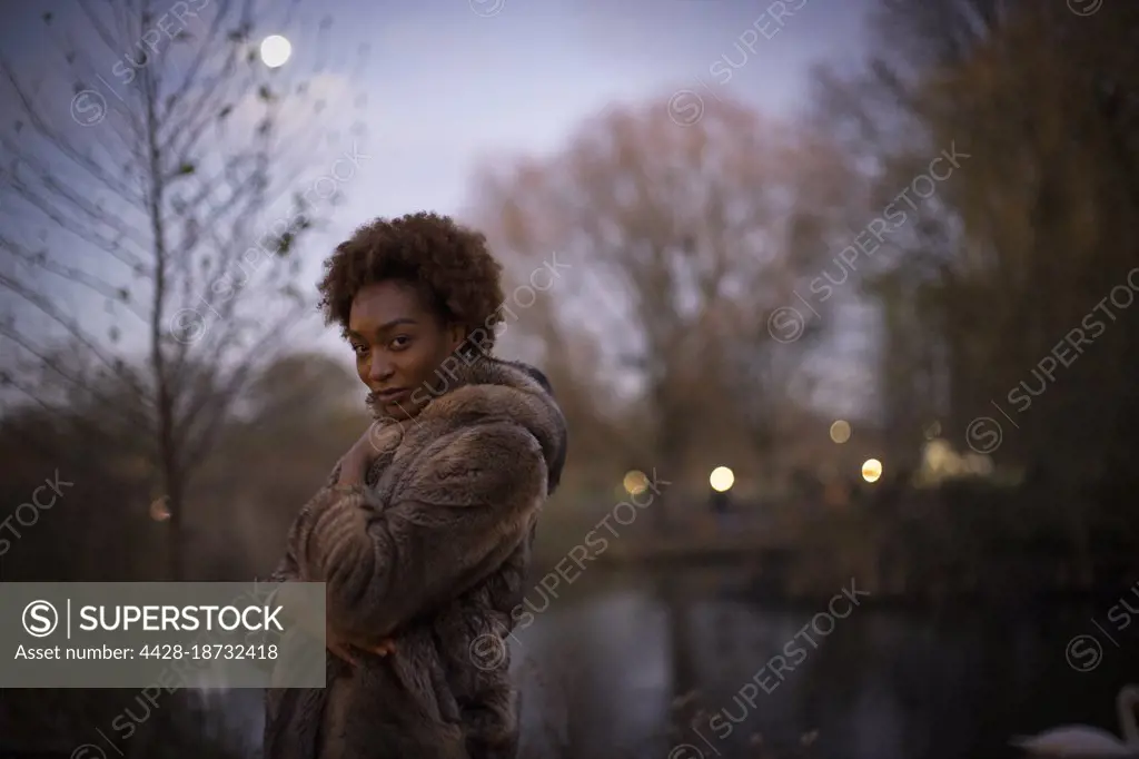 Portrait beautiful young woman in moonlit park at night