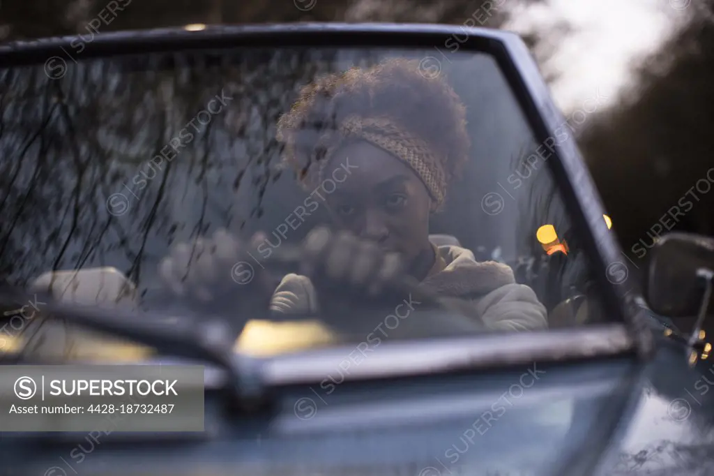 Beautiful young woman driving convertible