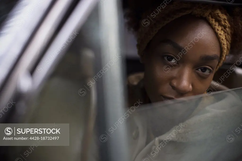Close up portrait beautiful young woman in car window