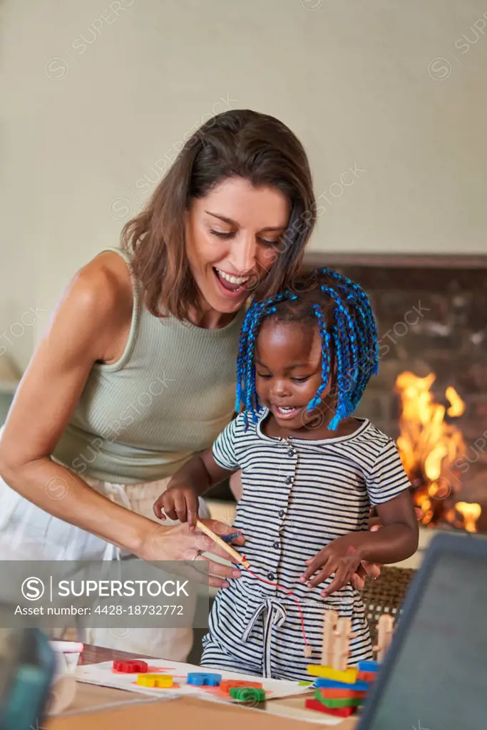 Mother and daughter playing at home