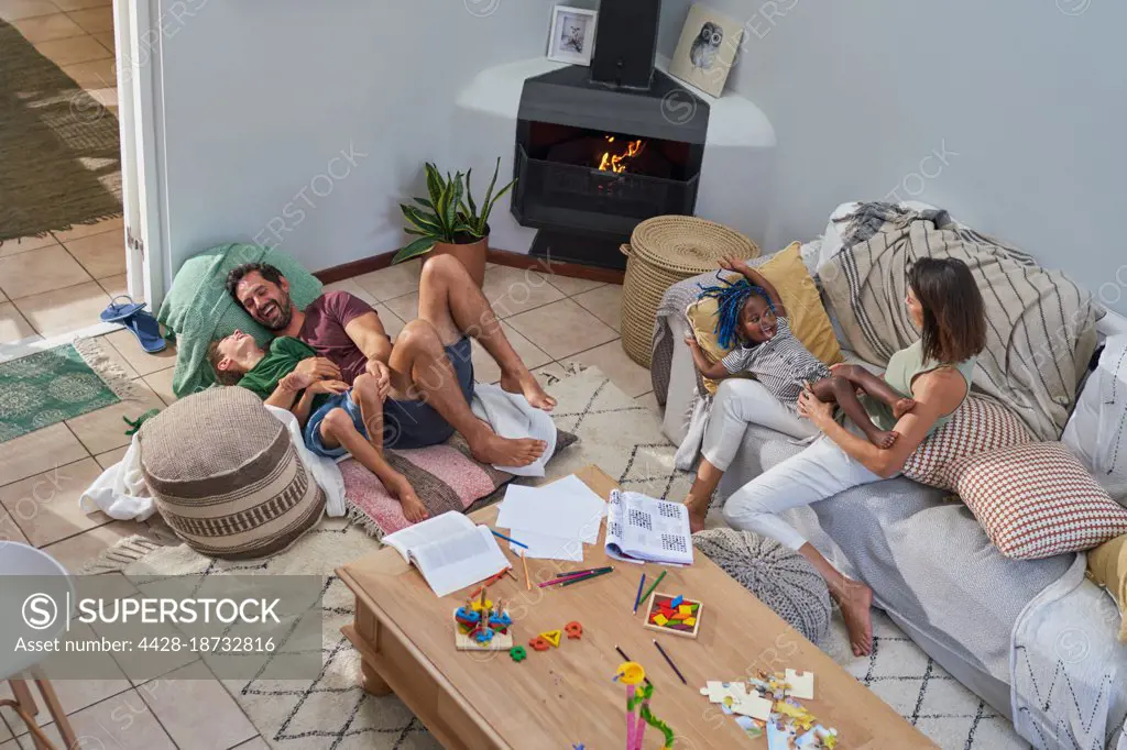 Happy family relaxing and playing in living room