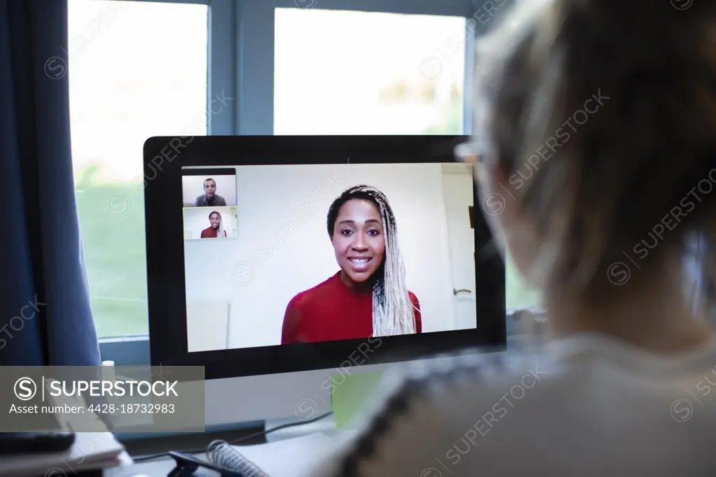 Businesswoman video conferencing with colleagues on computer screen