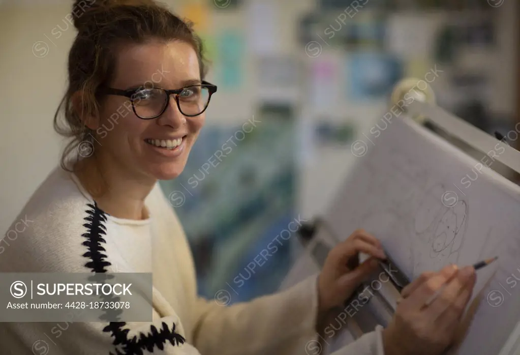 Portrait female architect working at drafting table