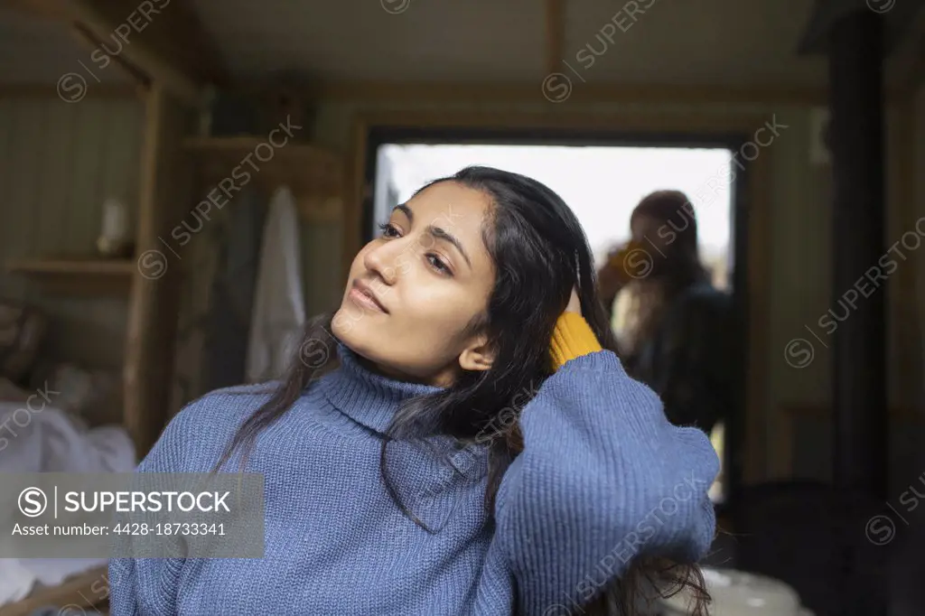 Beautiful young woman with hand in hair