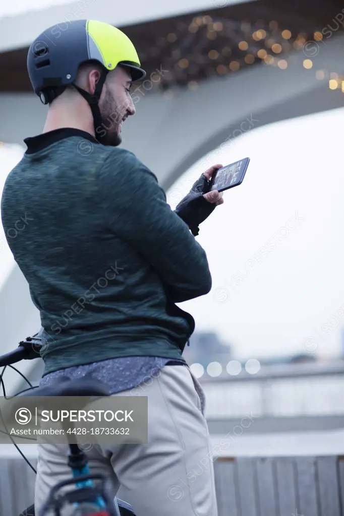 Man in bike helmet video chatting with smart phone