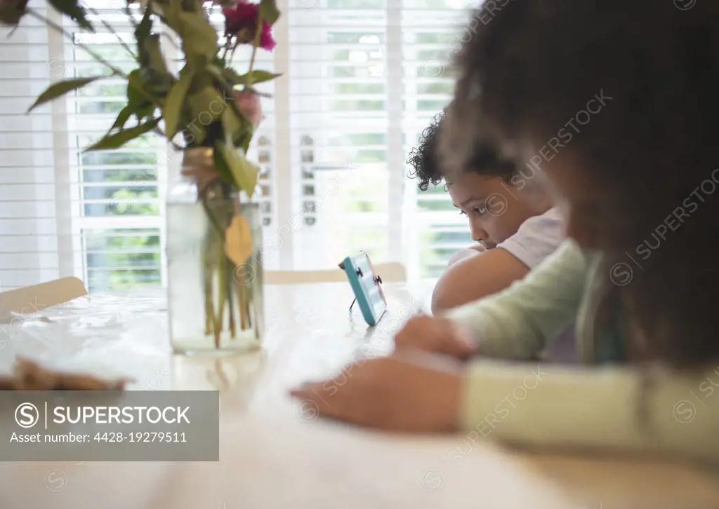 Boy with video game controller at table
