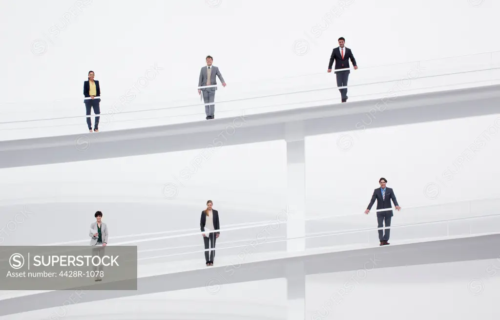 Spain, Portrait of business people at railings of elevated walkways