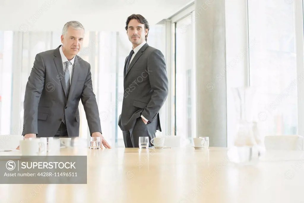 Businessmen standing at conference table