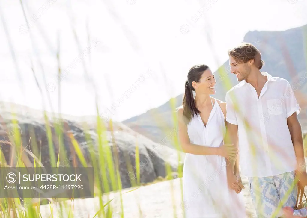 Couple walking together by beach