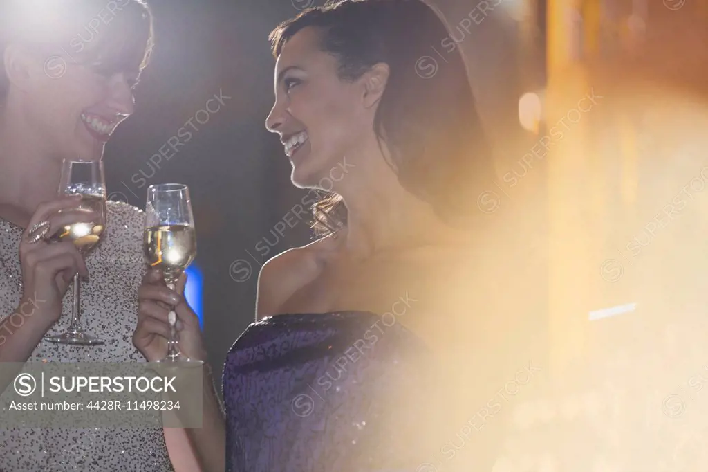 Well dressed women drinking champagne in luxury bar