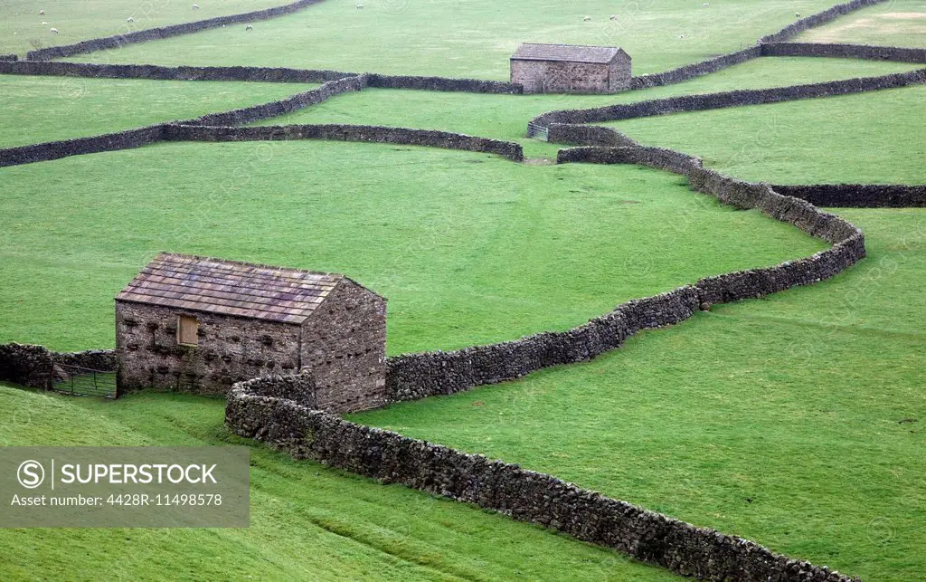 Stone houses and walls in green fields