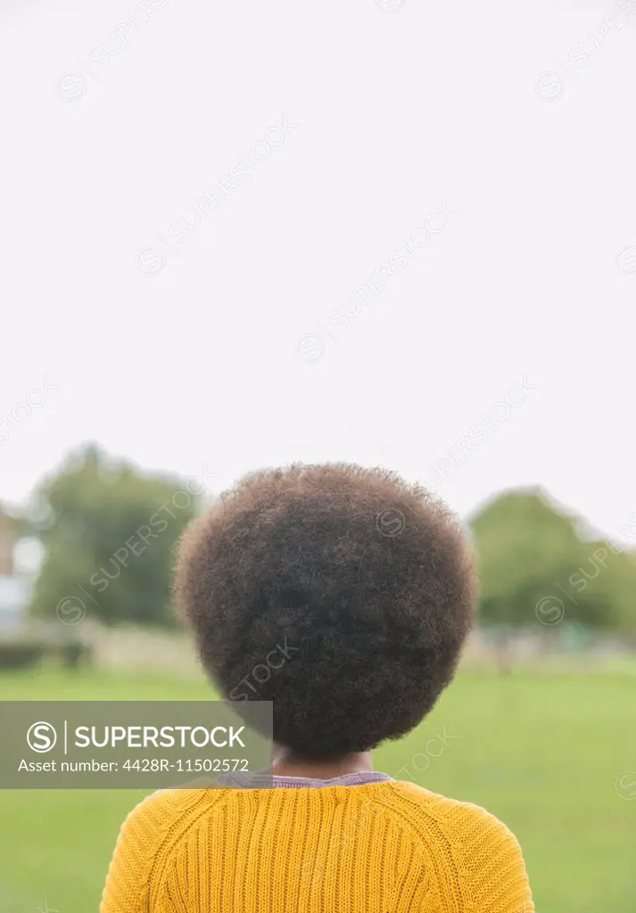 Woman with afro standing in park