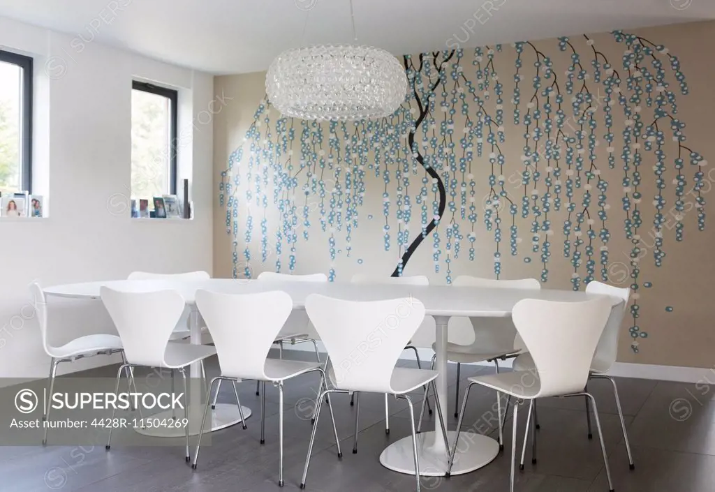 Wall art and chandelier in modern dining room