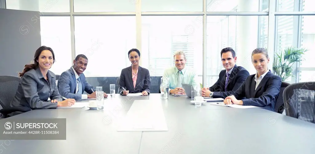 Portrait of confident business people at table in conference room
