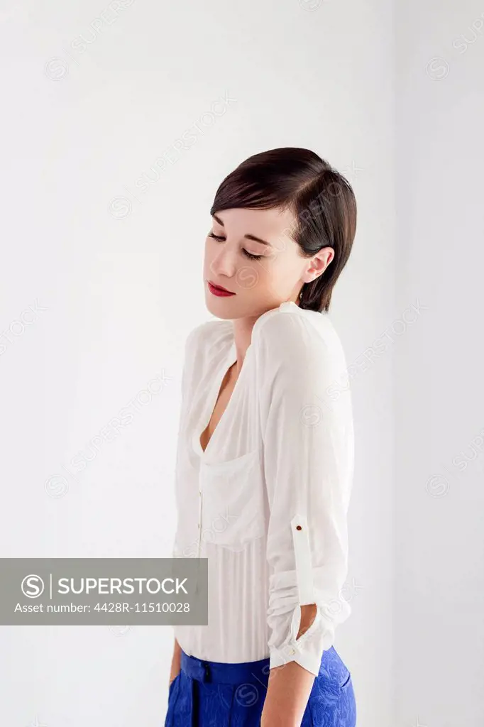Serious woman shrugging and looking down