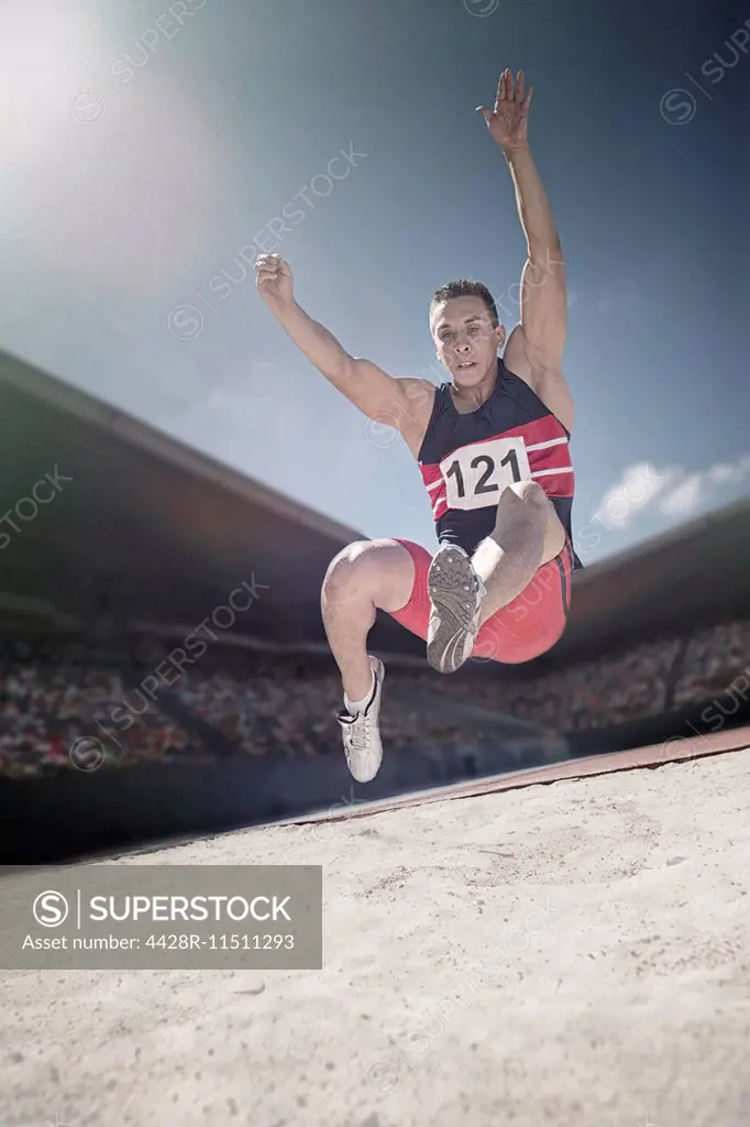 Long jumper above sand pit