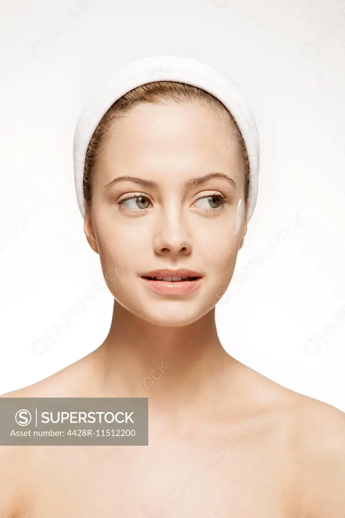 Close up of woman with moisturizer on cheek