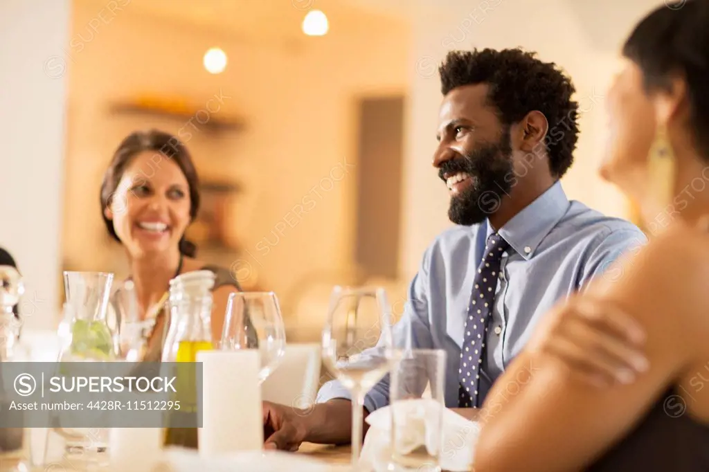 Friends laughing at dinner party
