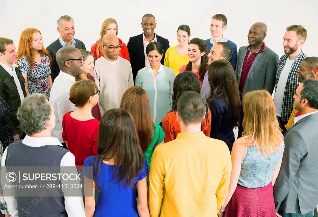 Diverse crowd meeting in circle