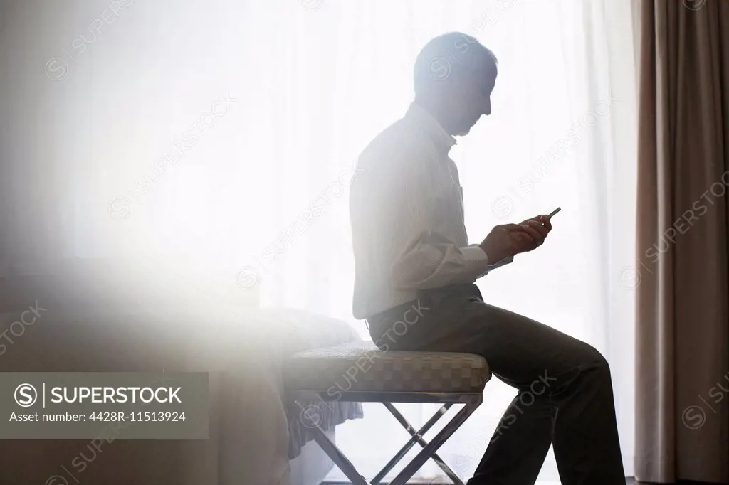 Silhouette of man using cell phone