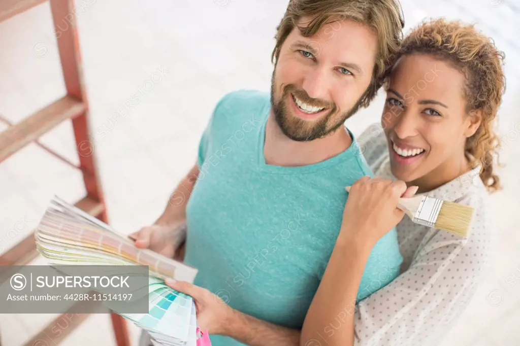 Couple looking through paint swatches together