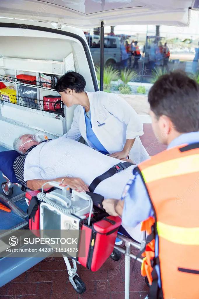Doctor examining patient on ambulance stretcher