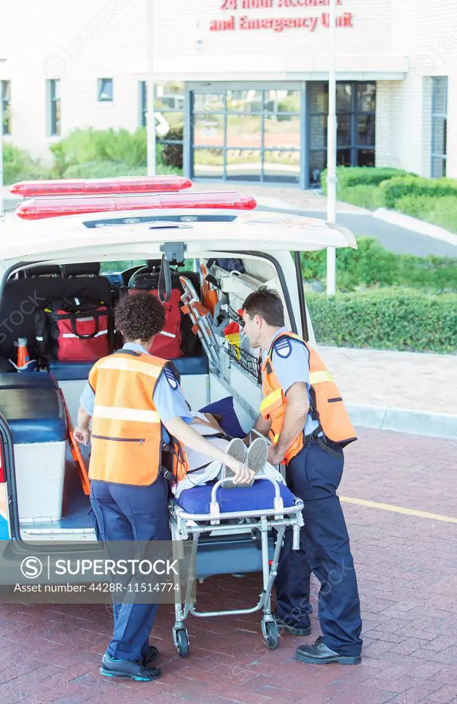 Paramedics wheeling patient out of ambulance