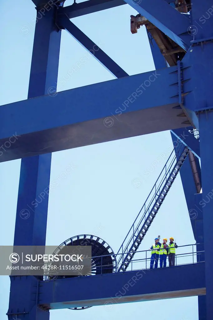 Workers standing on crane