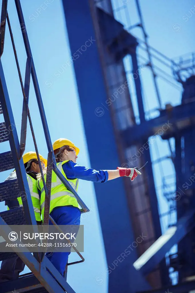 Low angle view of workers on cargo crane