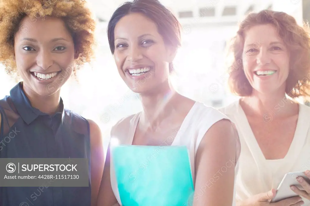 Portrait of three smiling businesswomen in office