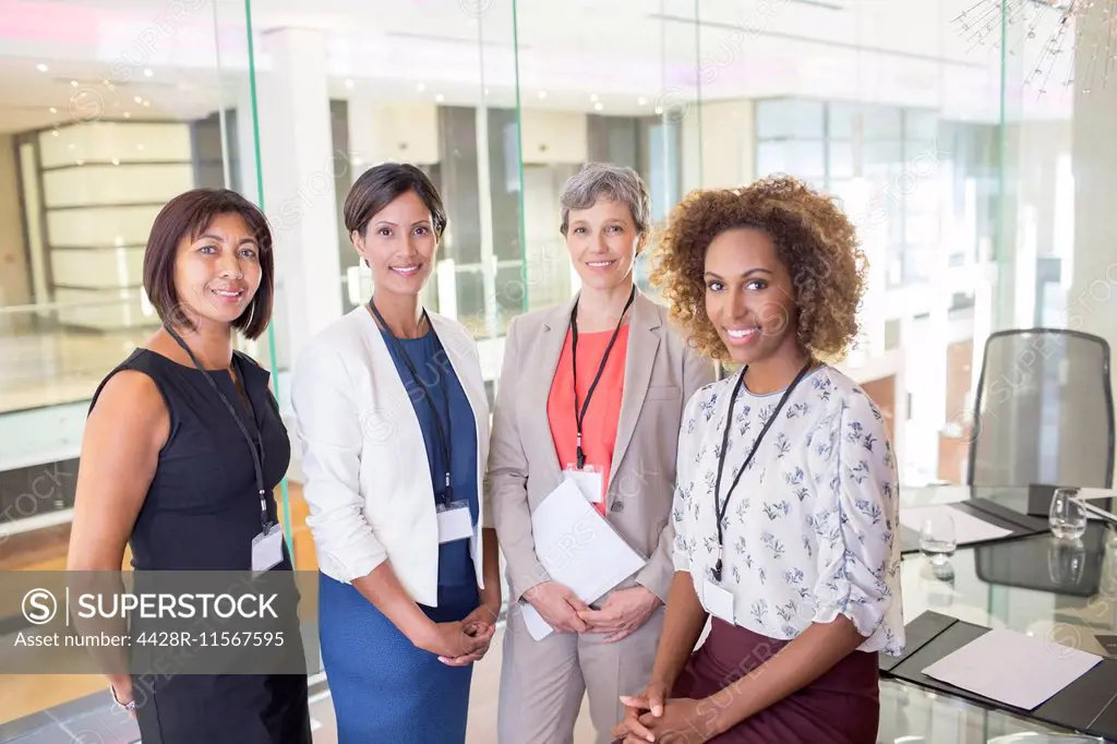 Portrait of four women standing in conference room