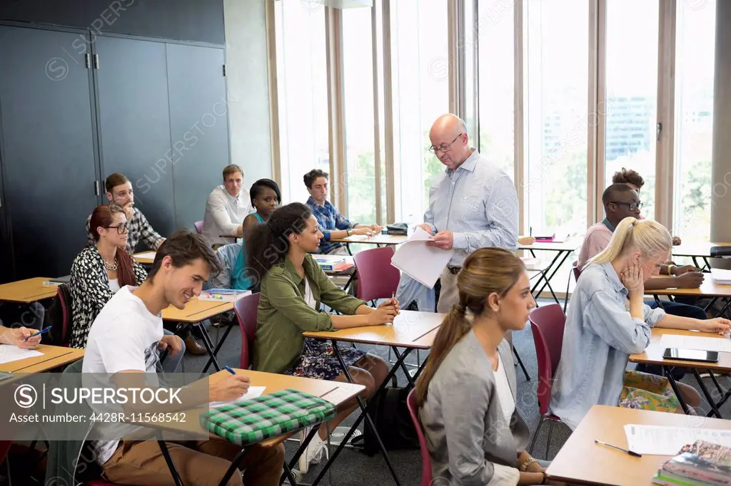 University students receiving test results from professor
