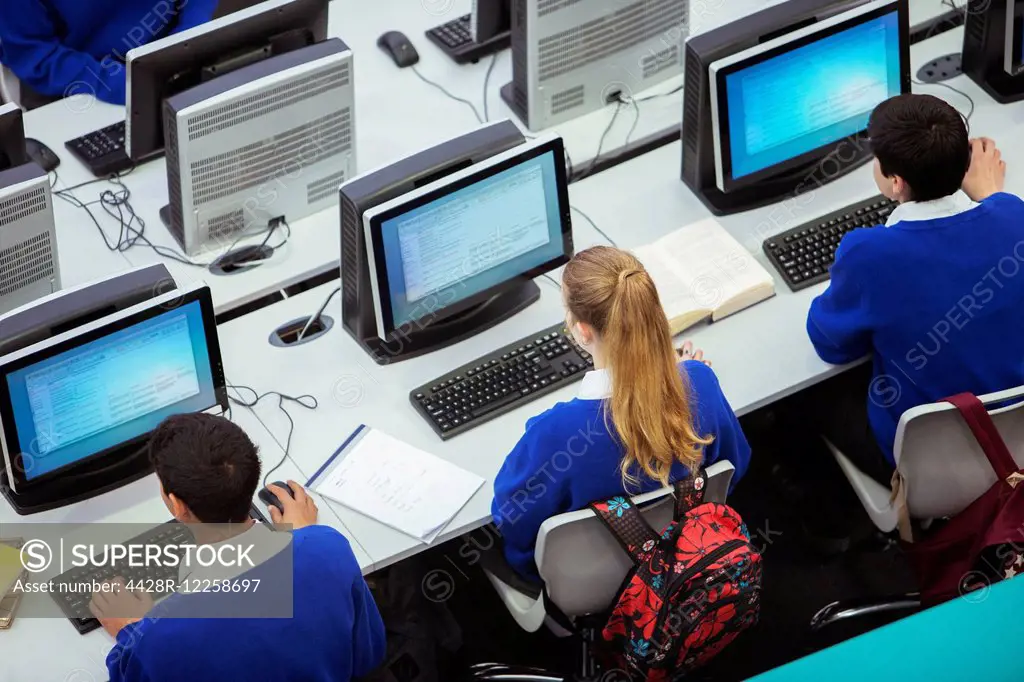 Elevated view of students sitting and learning in computer room