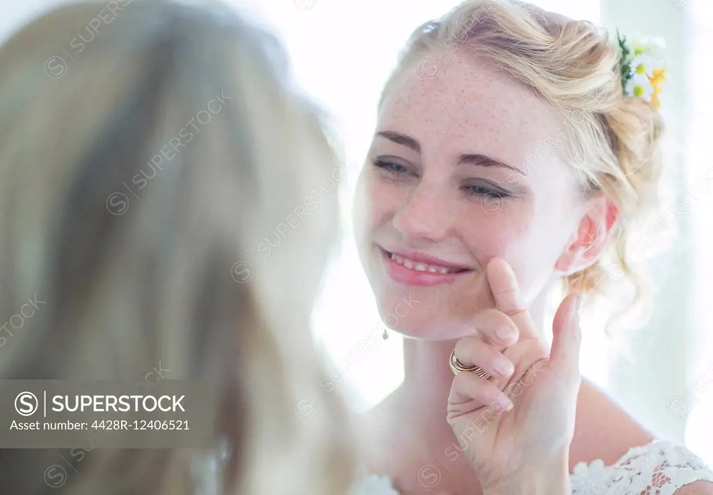 Matron of honor and bride facing each other and smiling