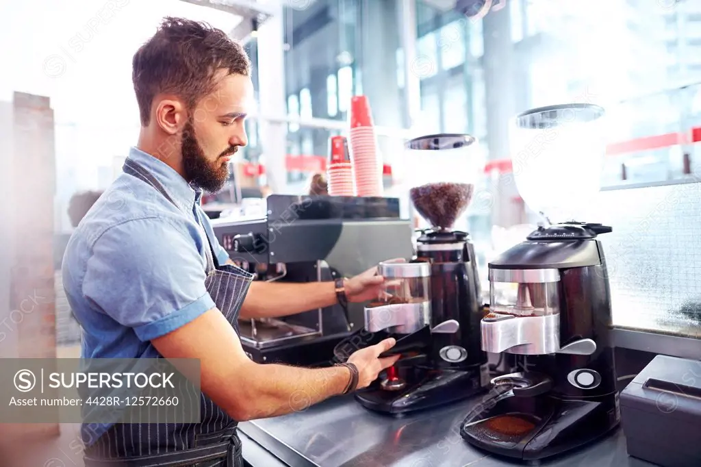 Barista making coffee in cafe