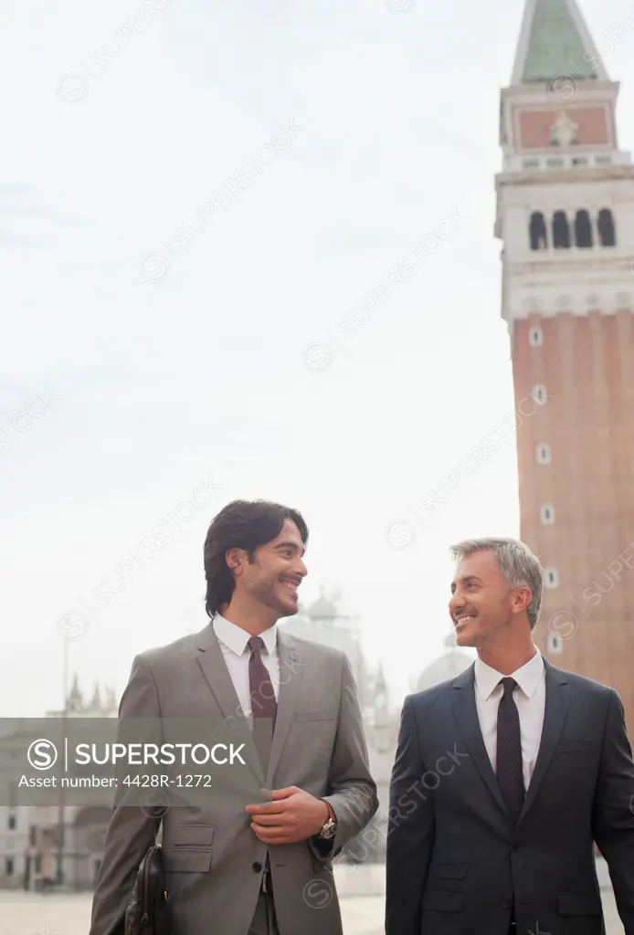 Venice, Smiling businessmen walking in St. Mark's Square in Venice