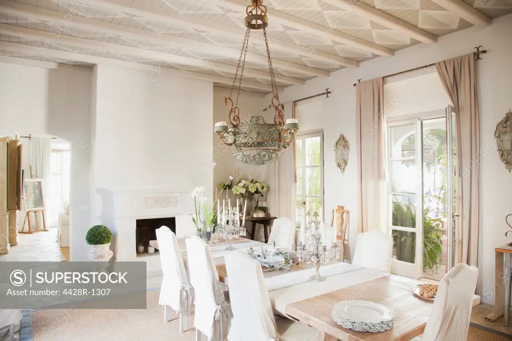 Spain, Chandelier over dining table in luxury dining room