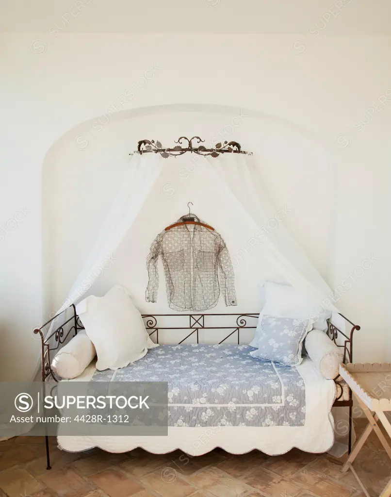 Spain, Shirt hanging over day bed with canopy on patio