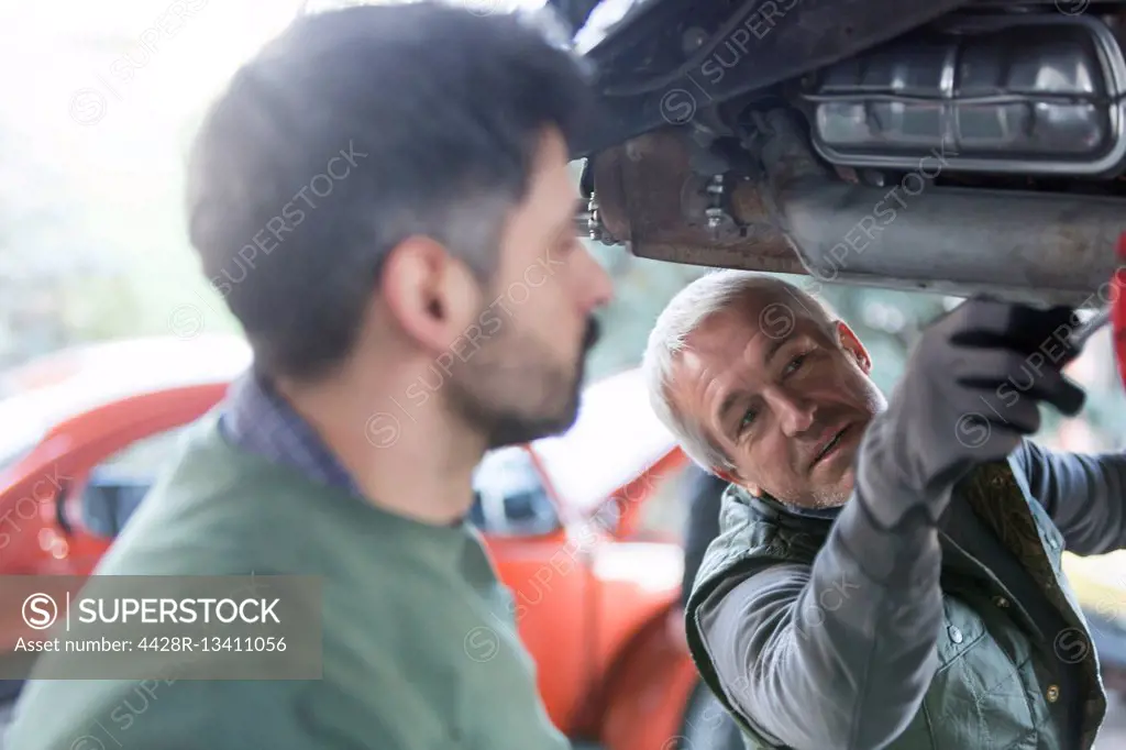 Mechanics repairing car in auto repair shop