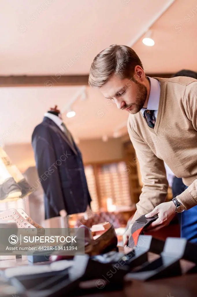 Businessman browsing socks in menswear shop