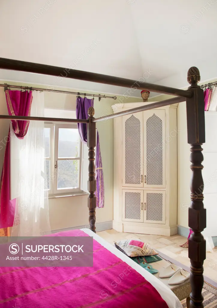 Spain, Four poster bed with purple bedding in bedroom