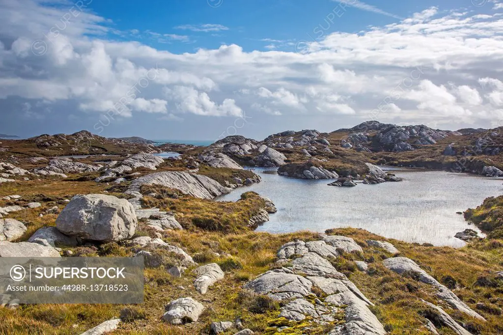 Sunny clouds over craggy rocks and water, Golden Road, Harris, Outer Hebrides